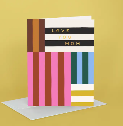 A vibrant Idlewild Co. Mother's Day card featuring hand-painted floral stripes and "Love You Mom" in gold foil.