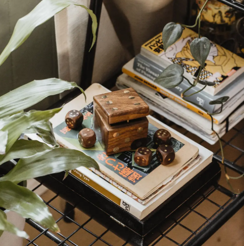 Style your living space with this handmade 5 Dice Box Set by Matr Boomie Fair Trade, beautifully displayed on a curated tabletop shelf.
