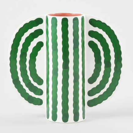 A modern green and white striped vase with a distinctive butterfly-like silhouette.