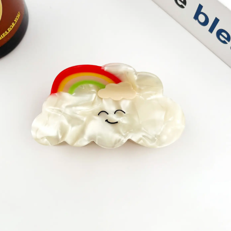 The Rainbow style Cute Cartoon Cloud Hair Clip by TheDivaSoap showcasing a colorful arched rainbow resting on top of a smiling cloud.