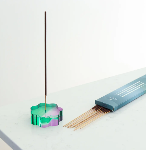 The Nimbus Duotone Acrylic Incense Holder, showing a cloud shape with a striking green and purple gradient, holding an incense stick.