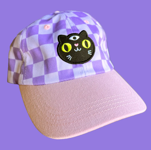 Top off your look! A stylish black cat checkerboard cap by Wokeface, perfect for adding a playful touch to your outfit.