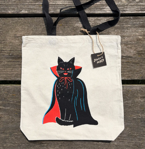 Showcase your spooky side with the Vampire Cat Neon Screenprinted Tote by Zander Mack, featuring vibrant retro cat art on natural cotton canvas.