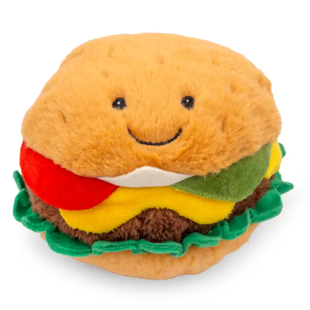 A plush cheeseburger dog toy with distinct layers of buns, meat, and cheese, featuring a large smiling embroidered face.