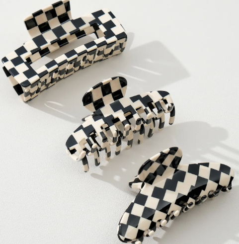 A set of large black and cream checkered claw clips by Adorro in various shapes including the Adrienne, Anna, and Luna styles.
