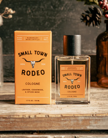 A 1.7 fl oz bottle of unisex Small Town Rodeo cologne featuring leather and cedarwood fragrance notes.