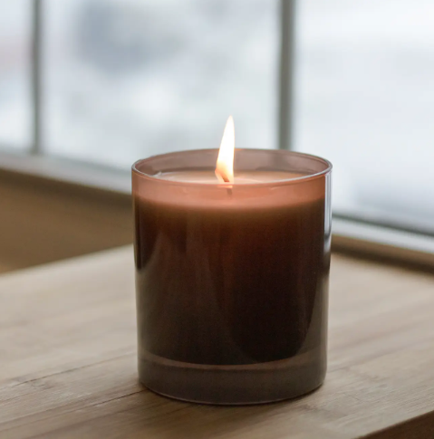 A close-up shot of the Sanctuary candle lit up, highlighting the premium design and modern aesthetic.