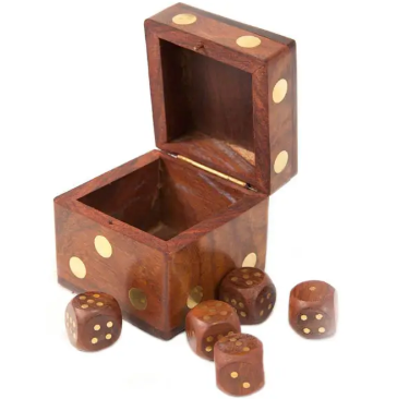 Styled tabletop arrangement featuring the hand-carved 5 Dice Box Set by Matr Boomie Fair Trade resting on books.
