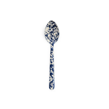 A durable enamelware serving spoon by Crow Canyon Home with a vibrant navy splatter pattern on a cream base.
