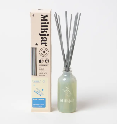 Hand-poured Canadian reed diffuser with spring rain and cotton scent notes in a simple, modern glass bottle.