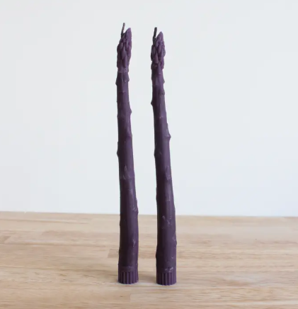 Style your dining room with lifelike purple or green asparagus taper candles, elegantly presented as artisan-made statement pieces that coordinate with modern farmhouse decor.