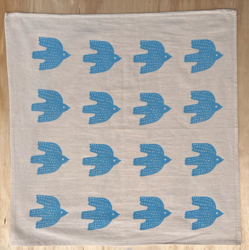 A lovely and fun hand-printed cotton tea towel with a bright bird design, ideal for a modern kitchen.