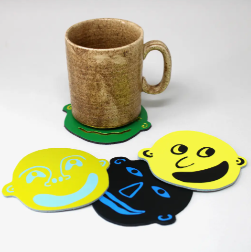 I'm All Ears - Set of 4 Leather Coasters by Ark Colour Design showcased with mug.