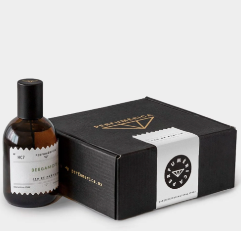 Bergamota Eau de Parfum by Perfumérica displayed next to its black, gold-accented presentation box.