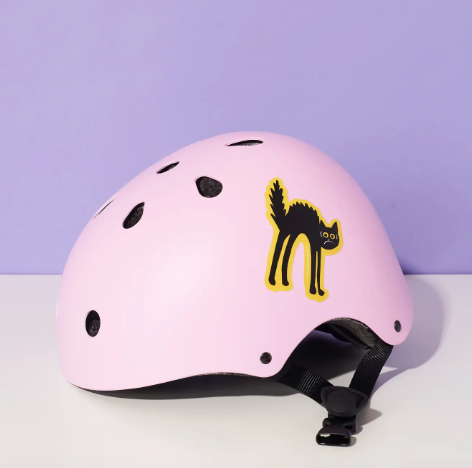 A pink helmet with the Black Cat Vinyl Sticker on the side.