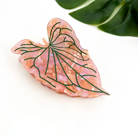 A delicate pink lotus leaf hair accessory featuring a polished surface and a sturdy claw grip.