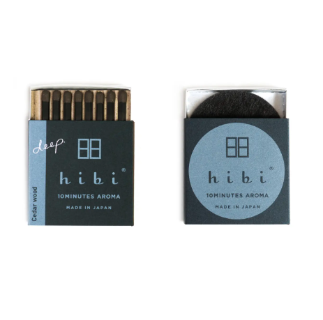 Open matchbox showcasing cedar wood hibi incense matches and the included burning pad by Ameico.