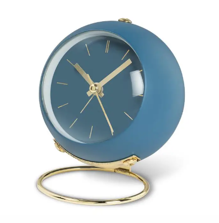 A sleek and modern ball alarm clock by Abbott featuring a minimalist loop stand in a sophisticated blue finish.