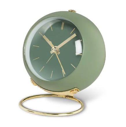 A sleek and modern ball alarm clock by Abbott featuring a minimalist loop stand in a sophisticated green finish.