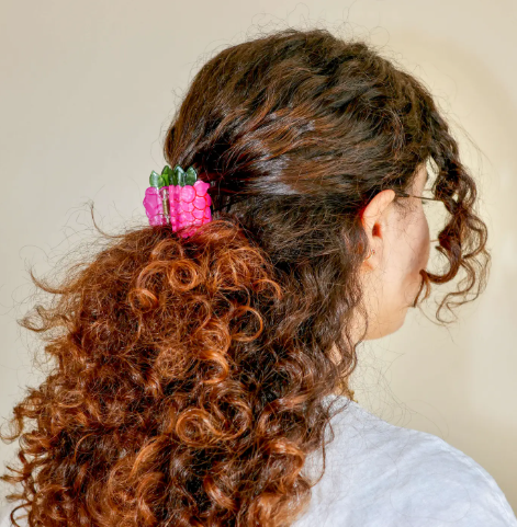 Elevate your snack-inspired fashion sense with a sustainable food-themed hair claw designed to bring a bold pop of color to fruit lovers everywhere.