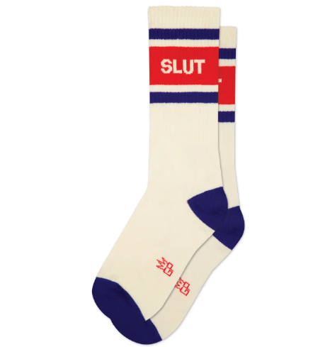 Walk with confidence in the Slut Gym Crew Socks by Gumball Poodle, a pair of retro cream-white athletic mid-calf socks featuring purple stripes and a bright red accent band.