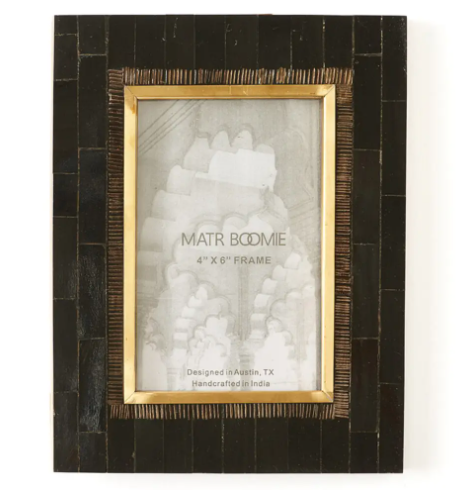 Highlight the art deco-inspired design of the Andhera Black Picture Frame by Matr Boomie Fair Trade, featuring hand-carved black horn and a gold-tone brass inlay.
