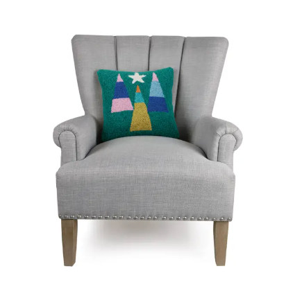 Starry Forest Hook Pillow by Peking Handicraft with colorful tree design and shining star displayed on chair.