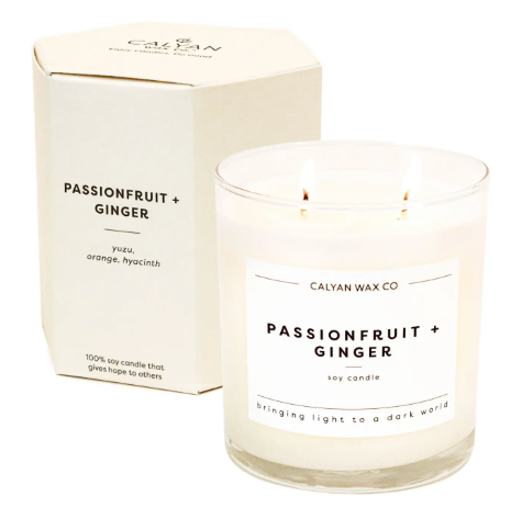 The elegant Passionfruit + Ginger candle in its custom cream hexagon box, highlighting its luxurious and giftable presentation.