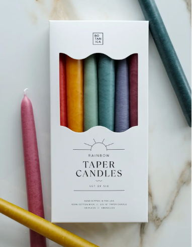 A vibrant Pride Collection set of 6 hand-dipped taper candles in a full spectrum of rainbow colors for a festive tabletop.