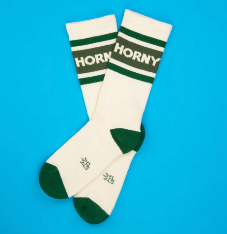 Keep your feet cozy in American-made novelty athletic socks that showcase a sporty striped style and a funny, no-nonsense statement text across the calf.