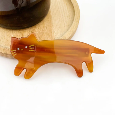 A glossy orange cat-shaped hair accessory by TheDivaSoap, showcasing a smooth and polished finish.
