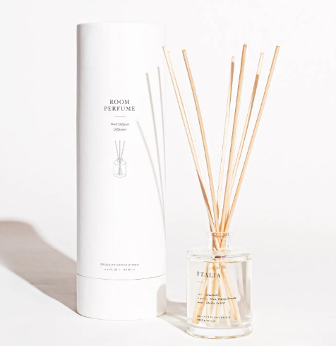 The elegant Brooklyn Candle Studio Italia Reed Diffuser in its screenprinted glass bottle and white cylindrical packaging tube.