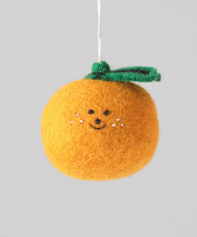 A round, orange felted wool Clementine Hanging Ornament with a simple stitched face and a green leaf cap.