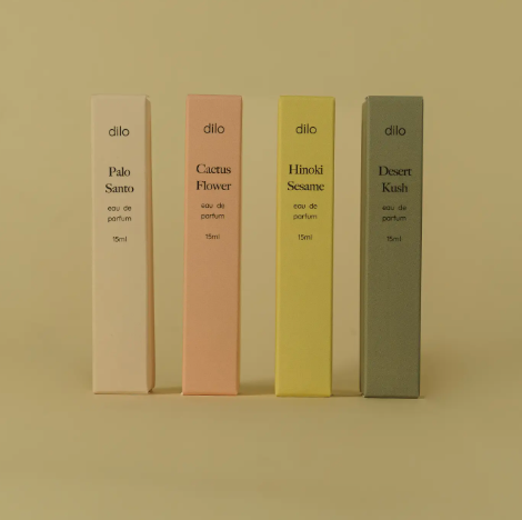 The Elsewhere Travel Sprayer collection by dilo featuring four sleek perfume bottles and their matching printed folded boxes.