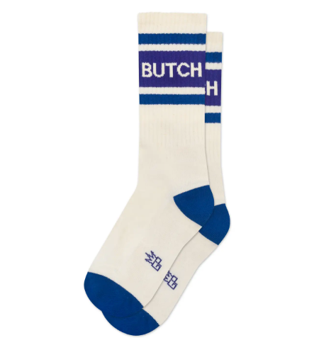 Step out with pride in the Butch Gym Crew Socks by Gumball Poodle, featuring a retro cream-white athletic design accented with bold blue stripes and purple bands.