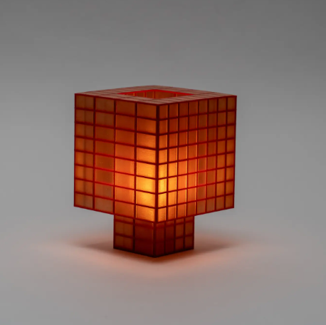 Display the Tesser 8-3 Lamp by Ridezign in amber, featuring a balanced medium height and soft orange illumination.