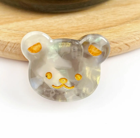 A gray bear head-shaped mini hair clip, showcasing its adorable and fun design.