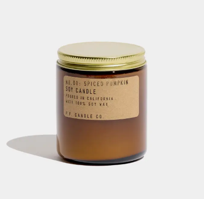 A classic 7.2 oz amber glass jar candle featuring a signature kraft label and a brass lid, ideal for seasonal home decor.