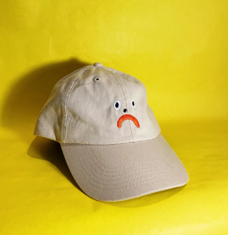 Stone-colored Kristina Micotti Sad Dad hat with black embroidery, a moody and stylish accessory for any head.