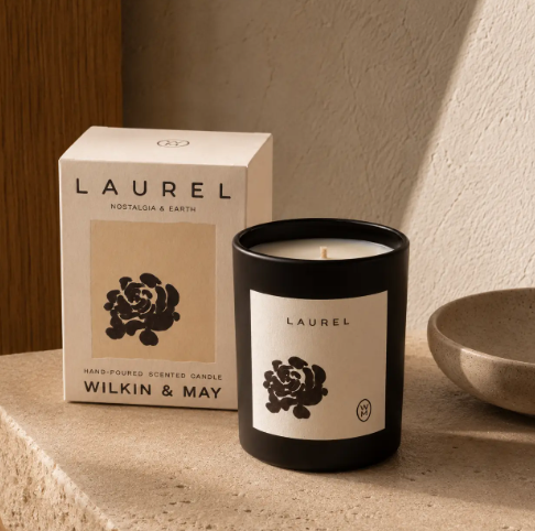 Elevate your botanical decor with the Laurel Luxury Candle by Wilkin & May, displayed next to its minimalist packaging on a textured surface.