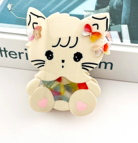 Adorable cat claw clip with colorful red and yellow butterfly details, a fun accessory for sunny days.