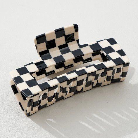 Close-up of the Luna style eco-friendly cellulose acetate material on an Adorro checkered hair clip, showing the unique pattern variations.
