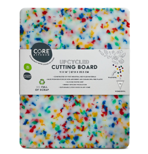 Brighten your kitchen counter with the Core Home Recycled Plastic Cutting Board in Medium Confetti, showing a colorful, flecked upcycled design from a side angle view.
