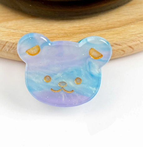 A light blue bear head-shaped mini hair clip, showcasing its adorable and fun design.