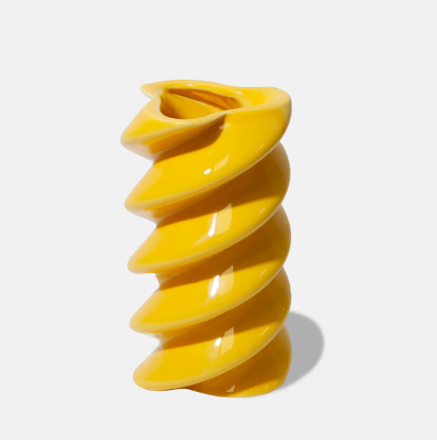 The DOIY Dolce Vita Vase, a glossy yellow ceramic vase with a distinct twisted, fusilli pasta shape.