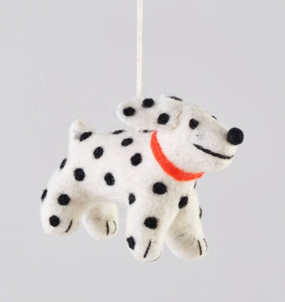 A white felted wool dog ornament with black spots (Dalmatian style) wearing a bright red collar.