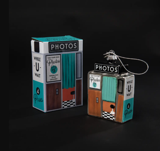 A festive holiday ornament designed as a retro photo booth, ready for gifting in its custom box.