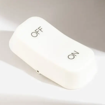 A sleek, modern bedside lamp with a minimalist design, highlighting its innovative touchless on/off function.