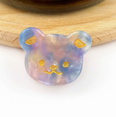 A purple beige bear head-shaped mini hair clip, showcasing its adorable and fun design.
