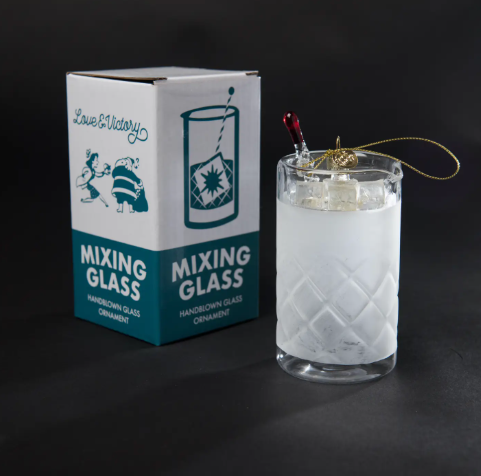 A celebratory glass ornament designed for the home bartender and cocktail aficionado packaged in a custom-designed box with a retro holiday design.